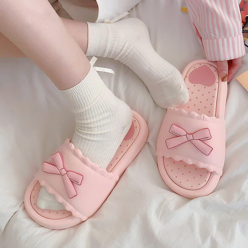Pink EVA slide sandals with a matching 3D pink bow and white scalloped edge, durable indoor shoes with patterned footbed