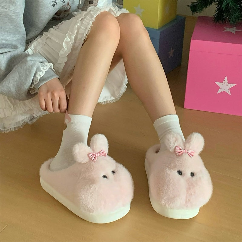 Cute pink bunny plush slippers with bow on ear and black dot eyes, closed-back fuzzy indoor shoes with EVA sole