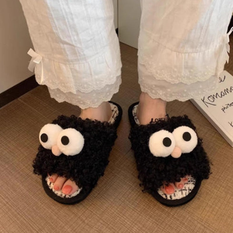 Black curly plush slippers featuring large white protruding eyes and a peach pom-pom, woven footbed indoor footwear with PVC sole