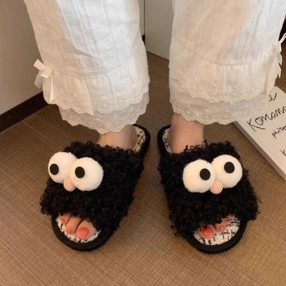 Black curly plush slippers featuring large white protruding eyes and a peach pom-pom, woven footbed indoor footwear with PVC sole