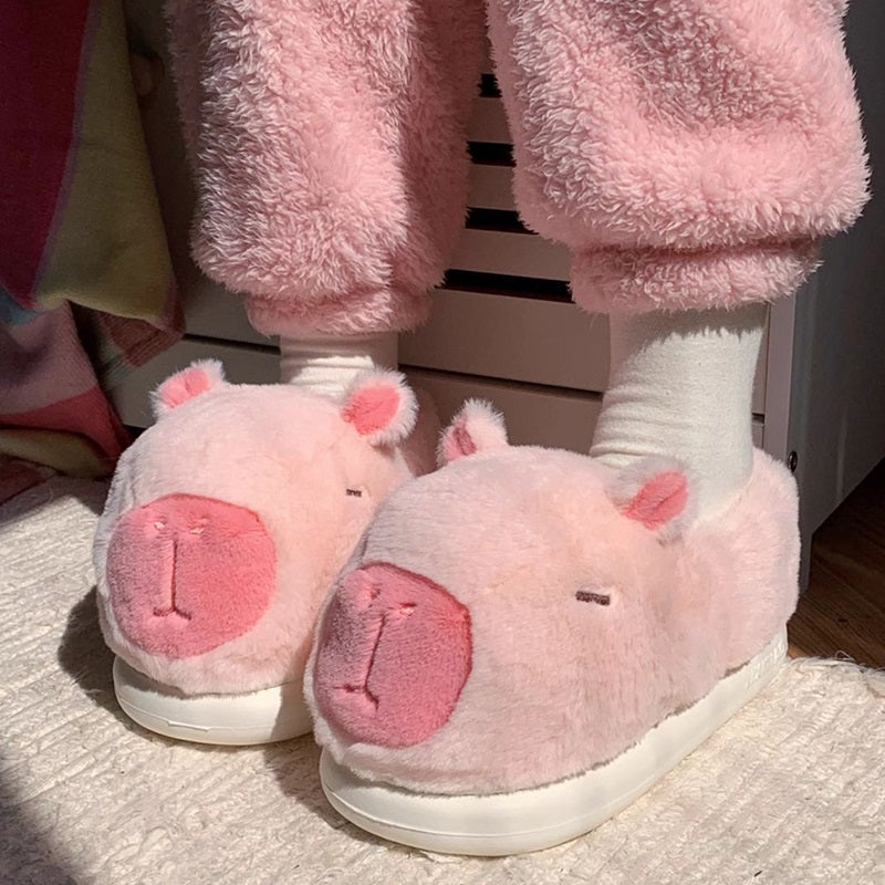 Cute pink capybara plush slippers with large rounded snout and small ears, closed-back fuzzy indoor shoes with EVA sole