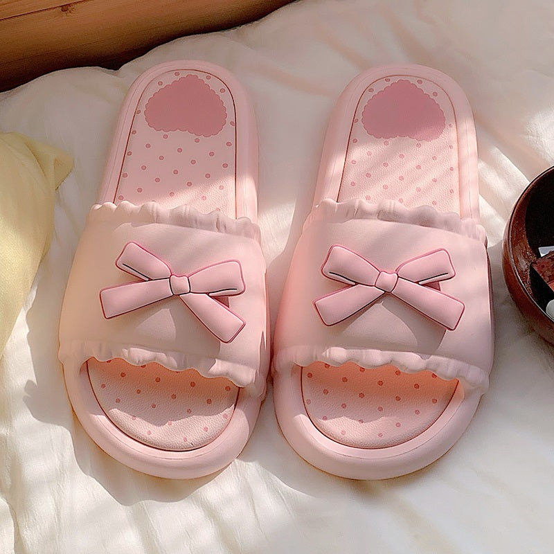 Pink EVA slide sandals with a matching 3D pink bow and white scalloped edge, durable indoor shoes with patterned footbed