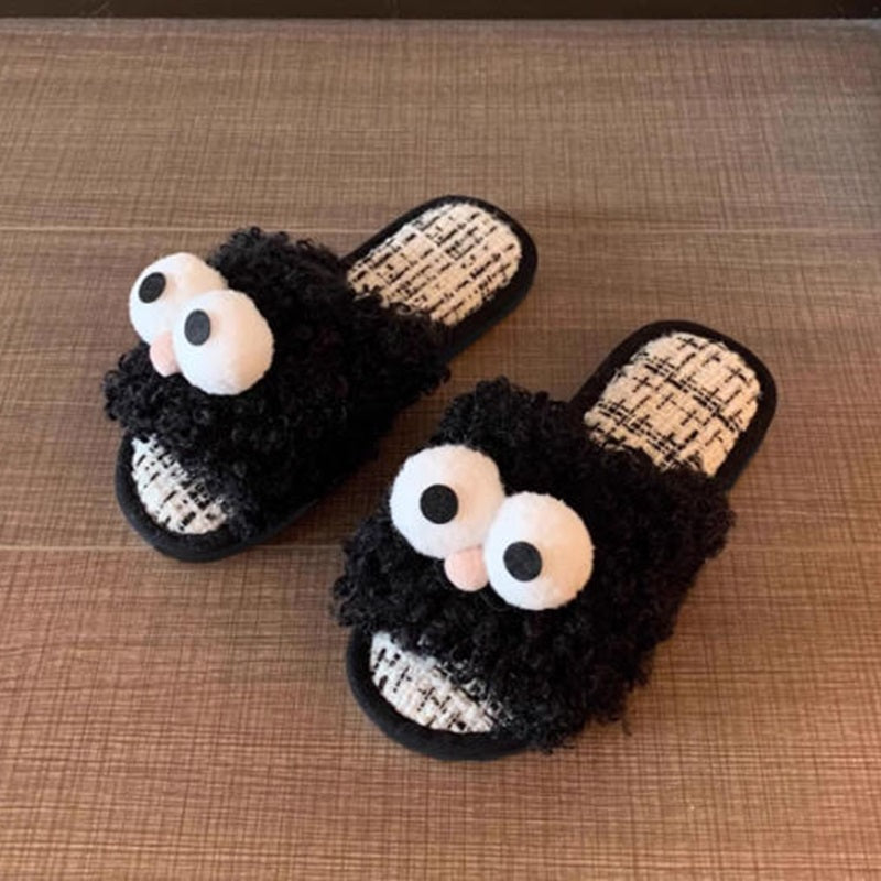 Black curly plush slippers featuring large white protruding eyes and a peach pom-pom, woven footbed indoor footwear with PVC sole