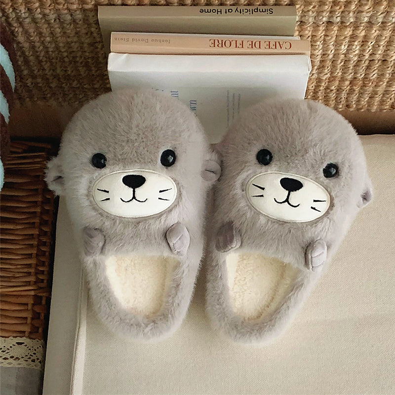 Adorable grey seal character plush slippers featuring a cream snout and whisker details, lightweight indoor footwear with EVA sole