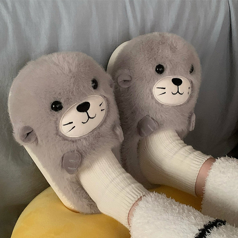 Adorable grey seal character plush slippers featuring a cream snout and whisker details, lightweight indoor footwear with EVA sole