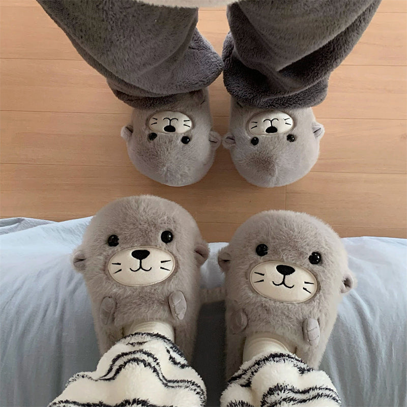 Adorable grey seal character plush slippers featuring a cream snout and whisker details, lightweight indoor footwear with EVA sole