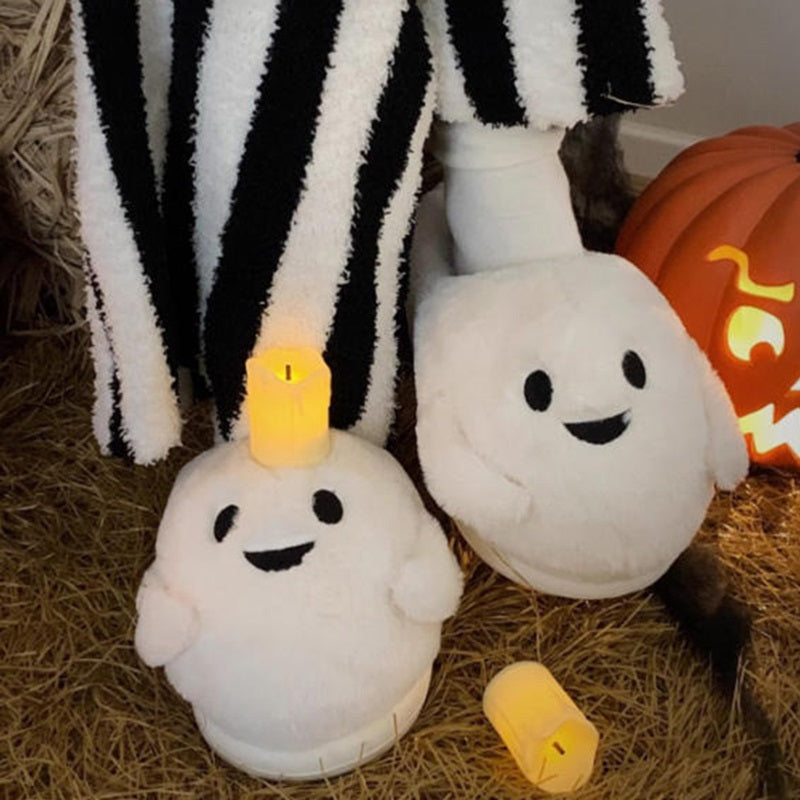 Playful white Halloween ghost face plush slippers featuring black dot eyes and a wavy smile, soft indoor footwear with EVA sole