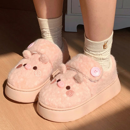 Cute pink pig plush slippers with button accent, pig face with snout and round ears, closed-back fuzzy indoor shoes with EVA sole