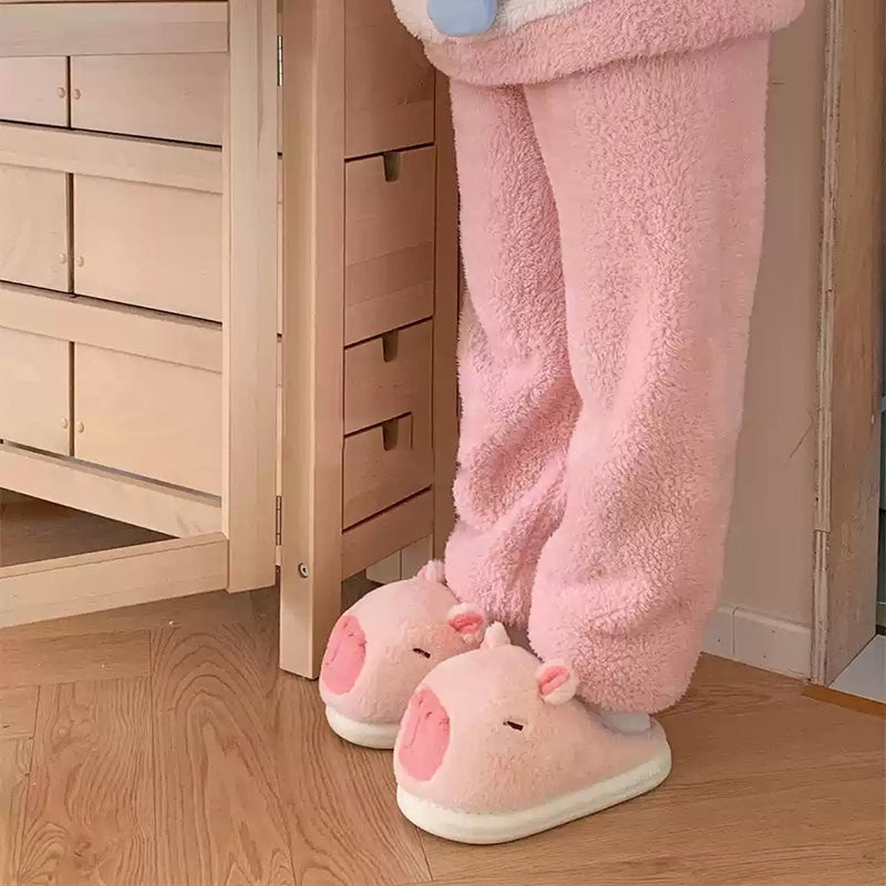 Cute pink capybara plush slippers with simple line eyes and round ears, fuzzy indoor shoes with EVA sole
