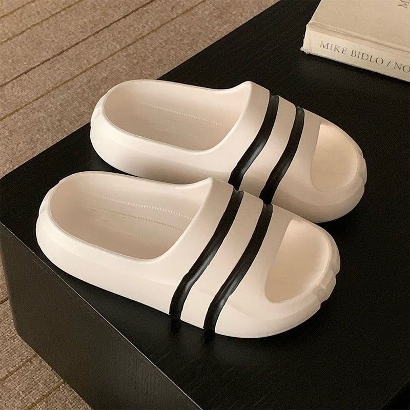 White wide-strap EVA slide sandals with black double stripes, all-EVA low-arch indoor shoes