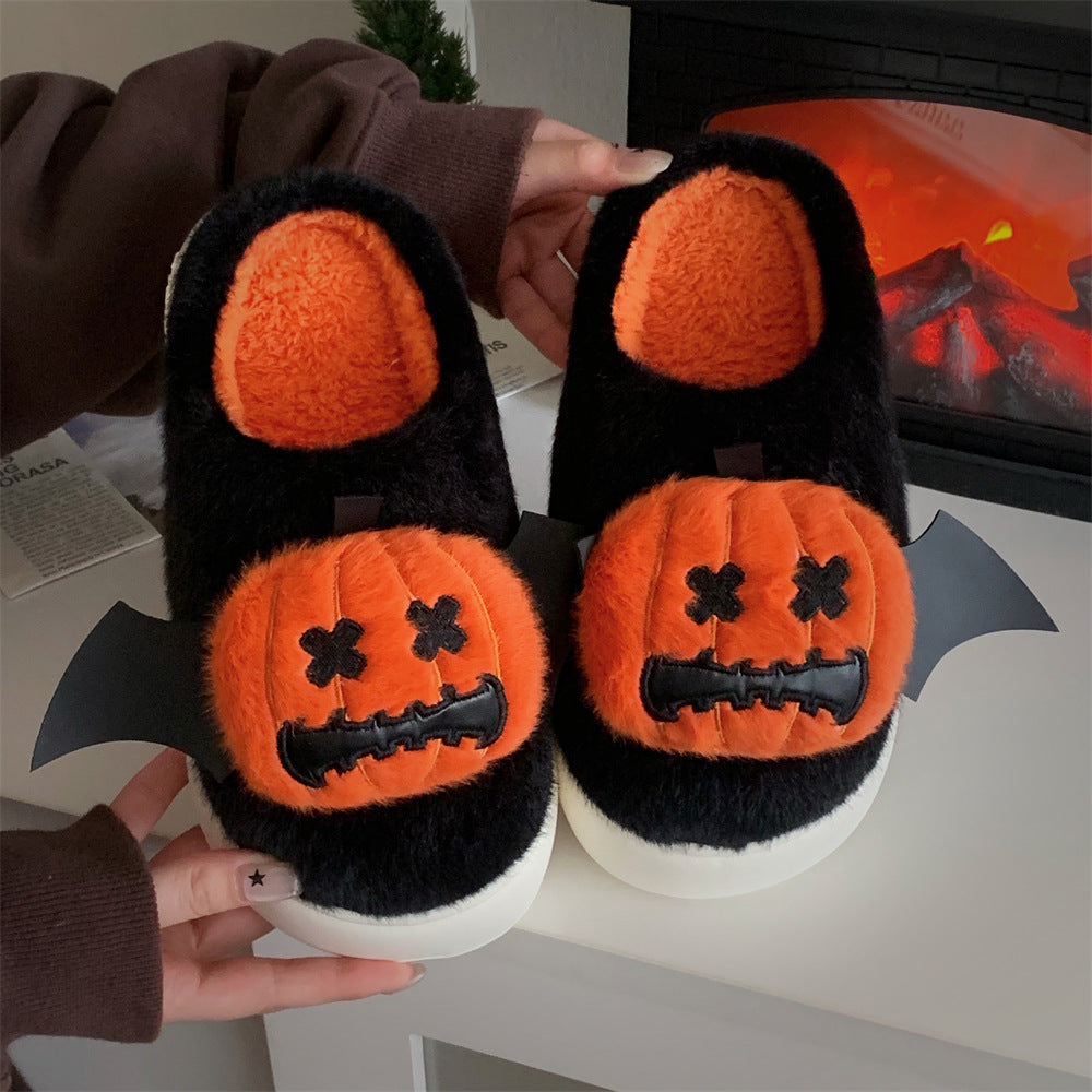 Cute black Halloween pumpkin plush slippers with bat wings and stitched face, fuzzy indoor shoes with EVA sole