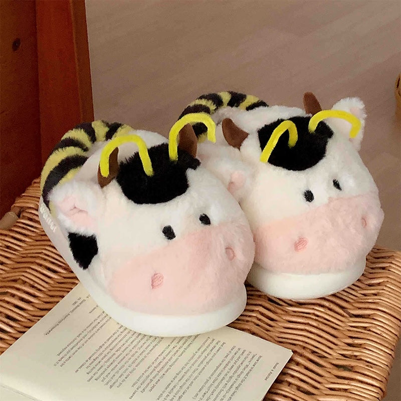 Cute pink cow and bee plush slippers with black patches, yellow stripes, and yellow antennae, closed-back fuzzy indoor shoes with EVA sole