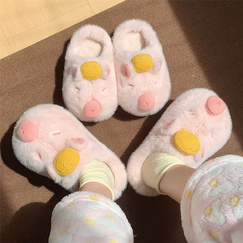 Cute pink capybara plush slippers with gold ingot on head and closed eyes, fuzzy indoor shoes with TPR sole
