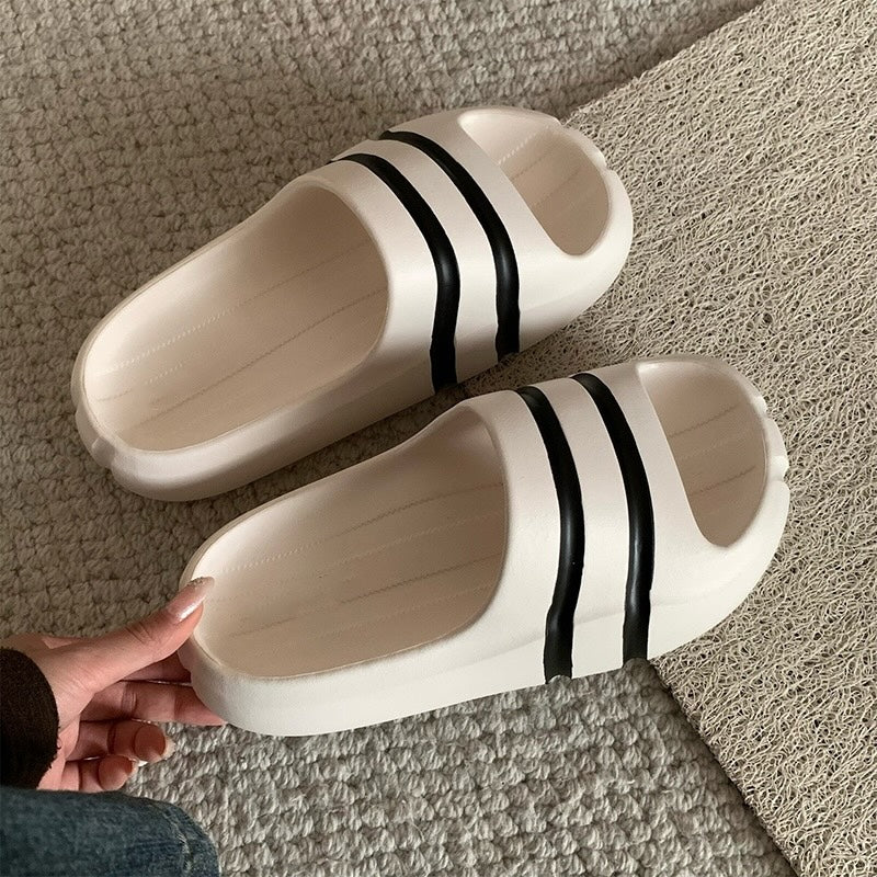 White wide-strap EVA slide sandals with black double stripes, all-EVA low-arch indoor shoes
