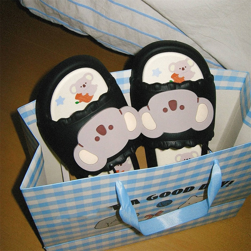 Cute black koala print EVA slide sandals with 3D koala face, ruffled trim, and star print footbed, all-EVA indoor slip-on shoes