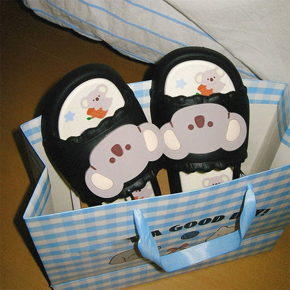 Cute black koala print EVA slide sandals with 3D koala face, ruffled trim, and star print footbed, all-EVA indoor slip-on shoes