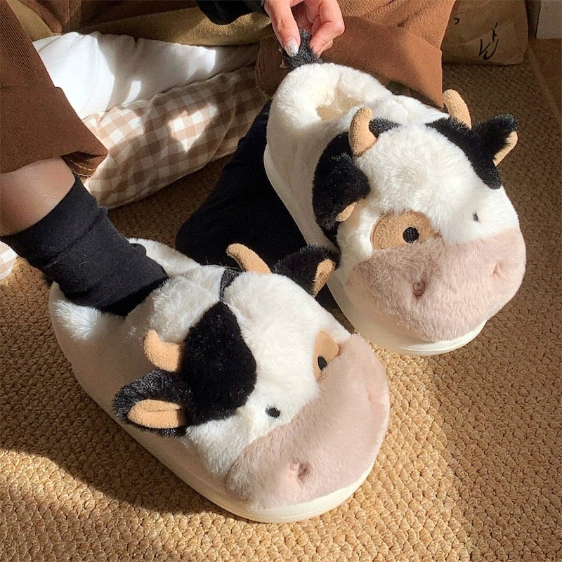 Cute black and white cow plush slippers with brown nose and horns, closed-back fuzzy indoor shoes with EVA sole