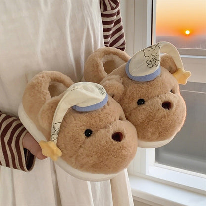 Cute khaki bear plush slippers with blue and white fabric hat and tiny smile, indoor shoes with EVA sole