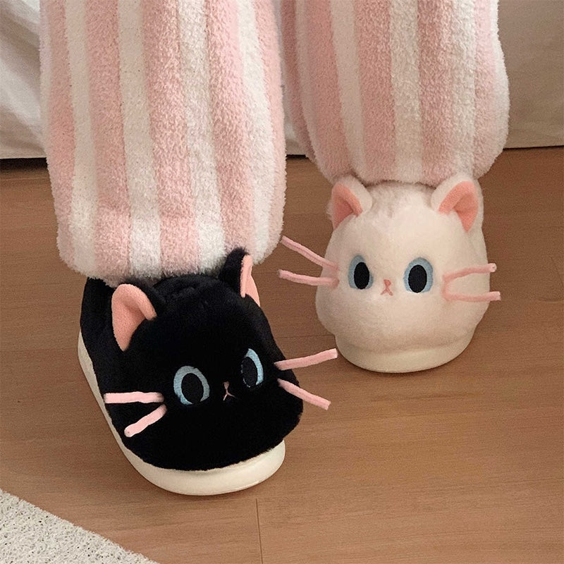 Cute black and white cat plush slippers with pink ears, blue eyes, and pink whiskers, closed-back fuzzy indoor shoes with EVA sole