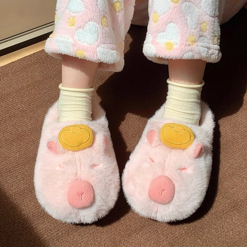 Cute pink capybara plush slippers with gold ingot on head and closed eyes, fuzzy indoor shoes with TPR sole