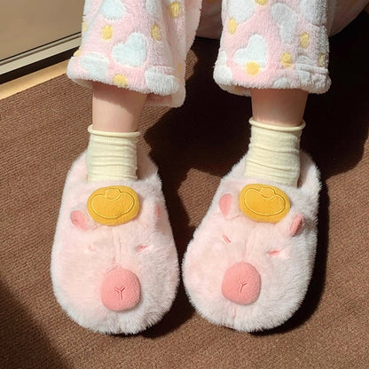 Cute pink capybara plush slippers with gold ingot on head and closed eyes, fuzzy indoor shoes with TPR sole