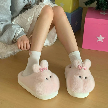 Cute pink bunny plush slippers with bow on ear and black dot eyes, closed-back fuzzy indoor shoes with EVA sole