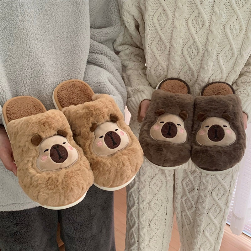 Brown fuzzy slippers featuring an embroidered capybara character with pink cheek accents, comfortable home shoes with PVC outsole