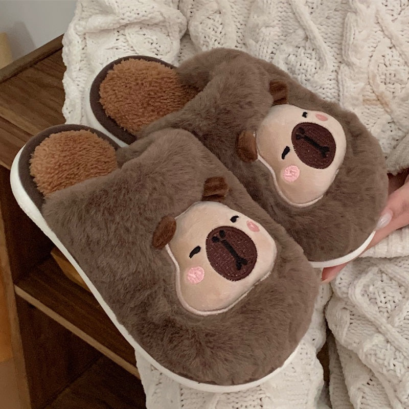 Brown fuzzy slippers featuring an embroidered capybara character with pink cheek accents, comfortable home shoes with PVC outsole