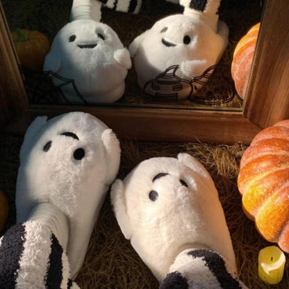 Playful white Halloween ghost face plush slippers featuring black dot eyes and a wavy smile, soft indoor footwear with EVA sole