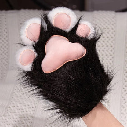 Black and white plush cat paw gloves featuring a large pink stitched main pad and white toe beans, soft performance mitts for cosplay