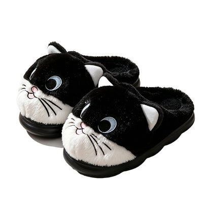 Black cat face plush slippers with white muzzle, blue eyes, and embroidered whiskers, fuzzy indoor footwear with EVA sole