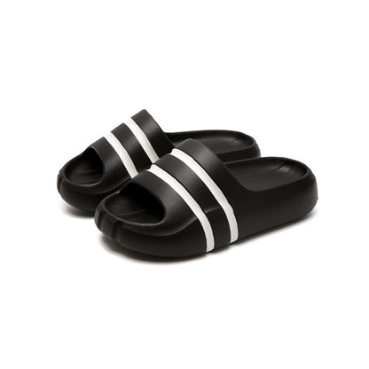 Black wide-strap EVA slide sandals with white double stripes, all-EVA low-arch indoor shoes