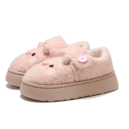 Cute pink pig plush slippers with button accent, pig face with snout and round ears, closed-back fuzzy indoor shoes with EVA sole