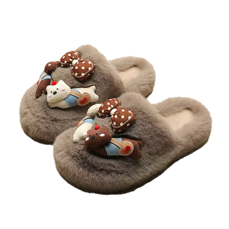 Grey plush slippers featuring a chunky bear with blue suspenders and a large polka-dot bow, cozy indoor shoes with rubber sole