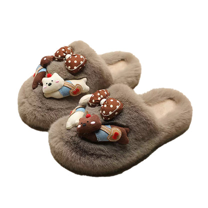 Grey plush slippers featuring a chunky bear with blue suspenders and a large polka-dot bow, cozy indoor shoes with rubber sole