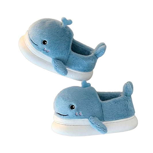 Light blue closed-back plush slippers shaped like a 3D whale with a spout and upturned tail, cozy indoor footwear with EVA sole