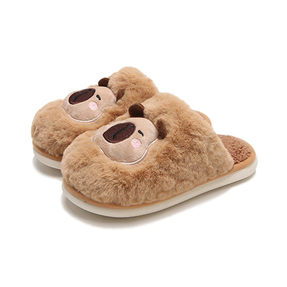 Light brown fuzzy plush slippers showcasing a capybara face with cream patch and dark snout, cozy indoor footwear with PVC sole