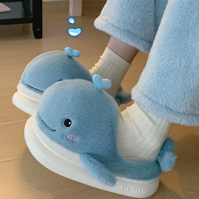 Light blue open-toe plush slippers shaped like a 3D whale with a top water spout and glossy eyes, soft indoor footwear with EVA sole