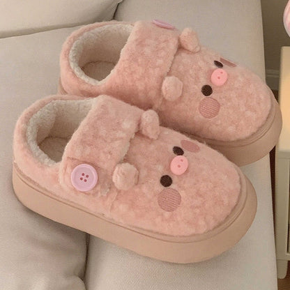 Cute pink pig plush slippers with button accent, pig face with snout and round ears, closed-back fuzzy indoor shoes with EVA sole