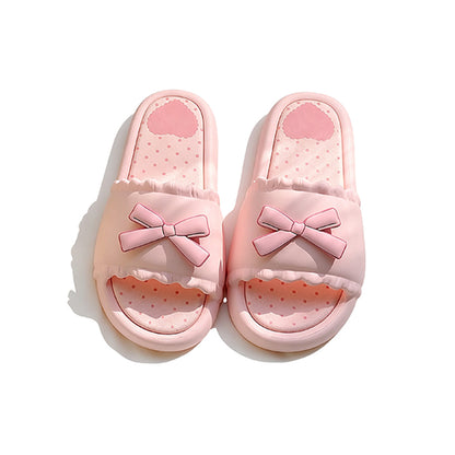 Pink EVA slide sandals with a matching 3D pink bow and white scalloped edge, durable indoor shoes with patterned footbed