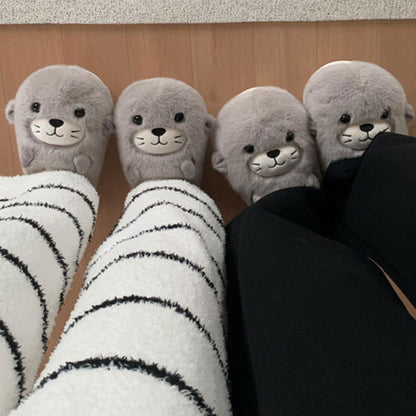 Adorable grey seal character plush slippers featuring a cream snout and whisker details, lightweight indoor footwear with EVA sole