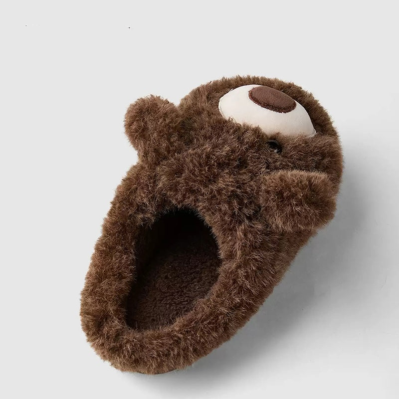 Dark brown shaggy bear plush slippers with a large white muzzle patch and a central fabric nose, cozy indoor footwear with TPR sole