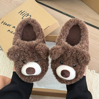 Dark brown shaggy bear plush slippers with a large white muzzle patch and a central fabric nose, cozy indoor footwear with TPR sole