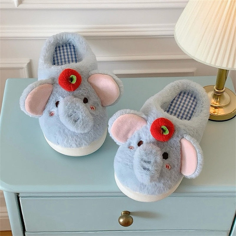Blue plush elephant slippers with large pink ears and a red apple top decoration, cozy indoor footwear with EVA sole