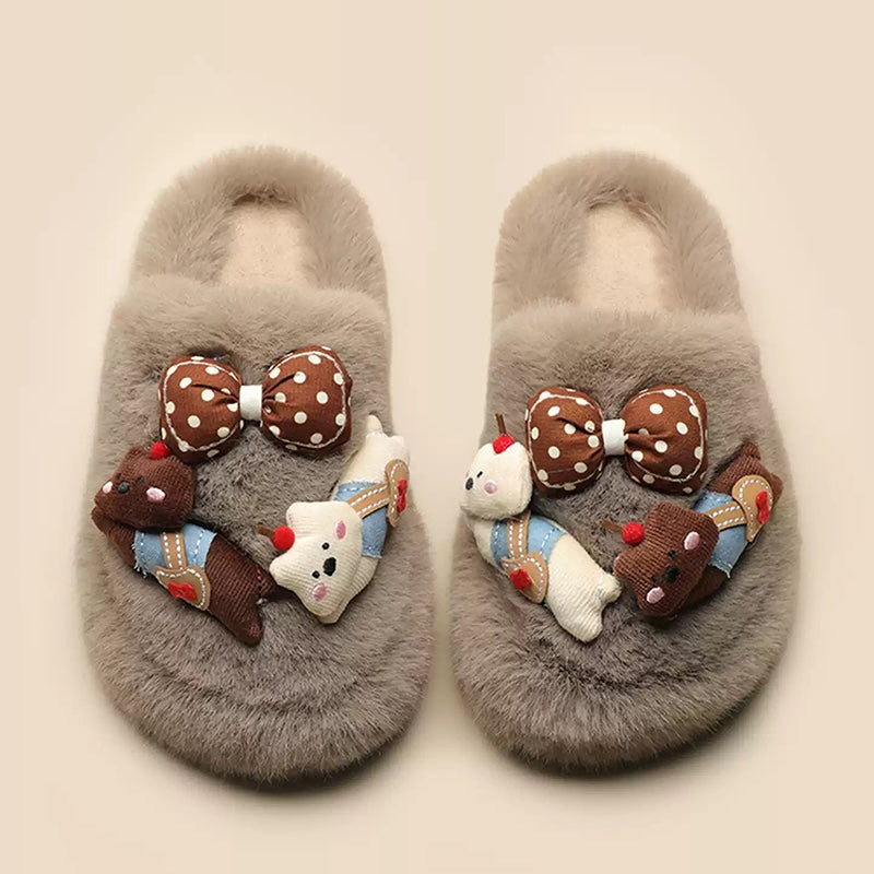 Grey plush slippers featuring a chunky bear with blue suspenders and a large polka-dot bow, cozy indoor shoes with rubber sole
