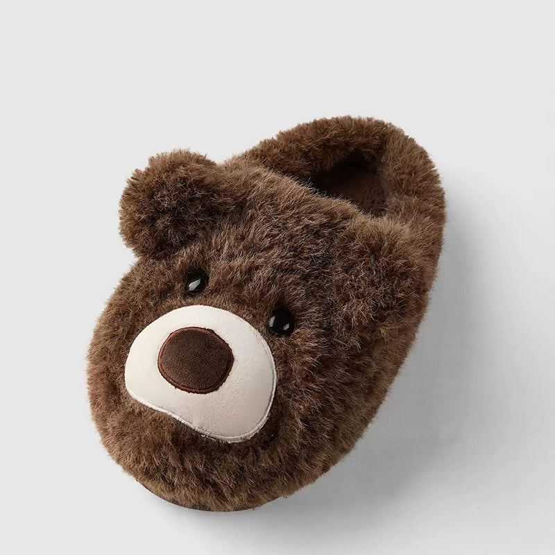 Dark brown shaggy bear plush slippers with a large white muzzle patch and a central fabric nose, cozy indoor footwear with TPR sole