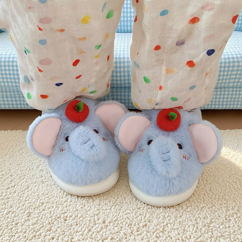 Blue plush elephant slippers with large pink ears and a red apple top decoration, cozy indoor footwear with EVA sole