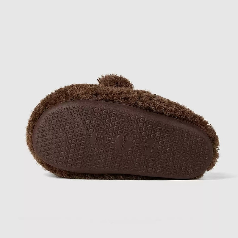 Dark brown shaggy bear plush slippers with a large white muzzle patch and a central fabric nose, cozy indoor footwear with TPR sole