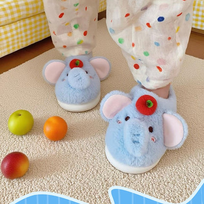 Blue plush elephant slippers with large pink ears and a red apple top decoration, cozy indoor footwear with EVA sole