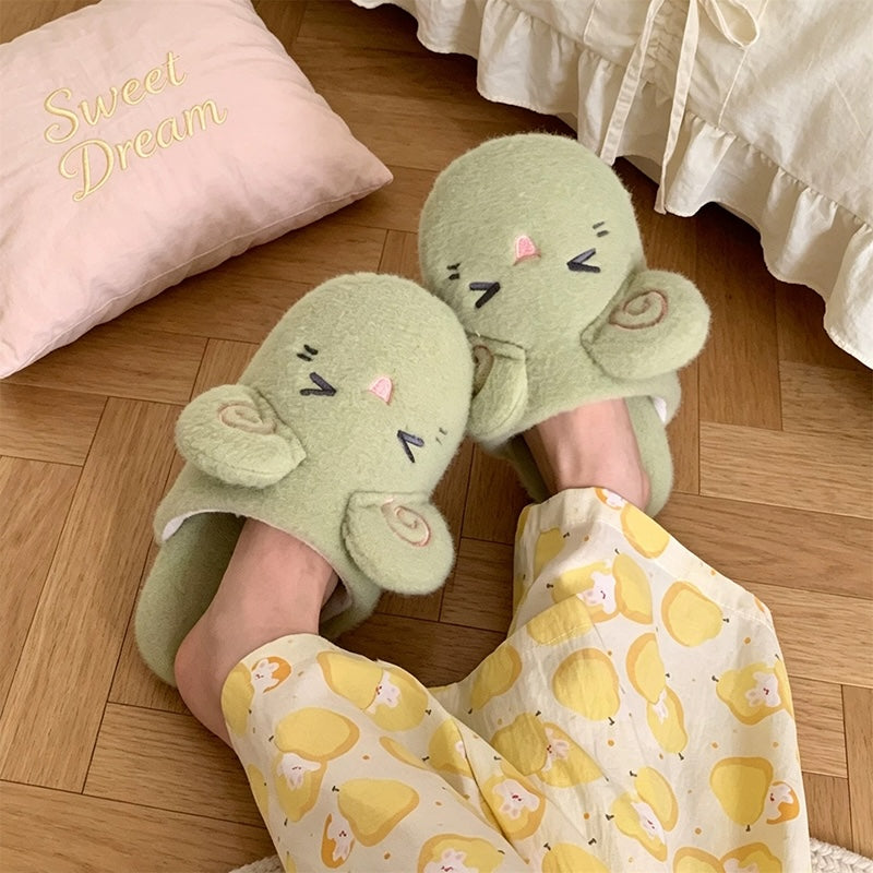 Green fleece sheep slippers designed with pink spiral ears and a smiling closed-eye look, lightweight fabric sole home shoes